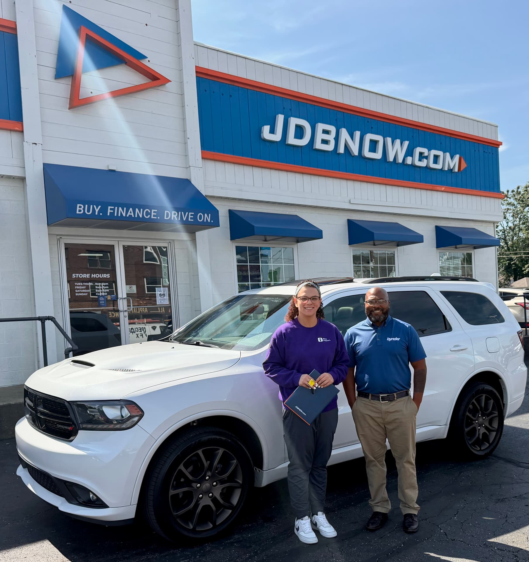 Byrider Canton customer and salesperson beside their used Dodge Durango at the Canton, Ohio dealership