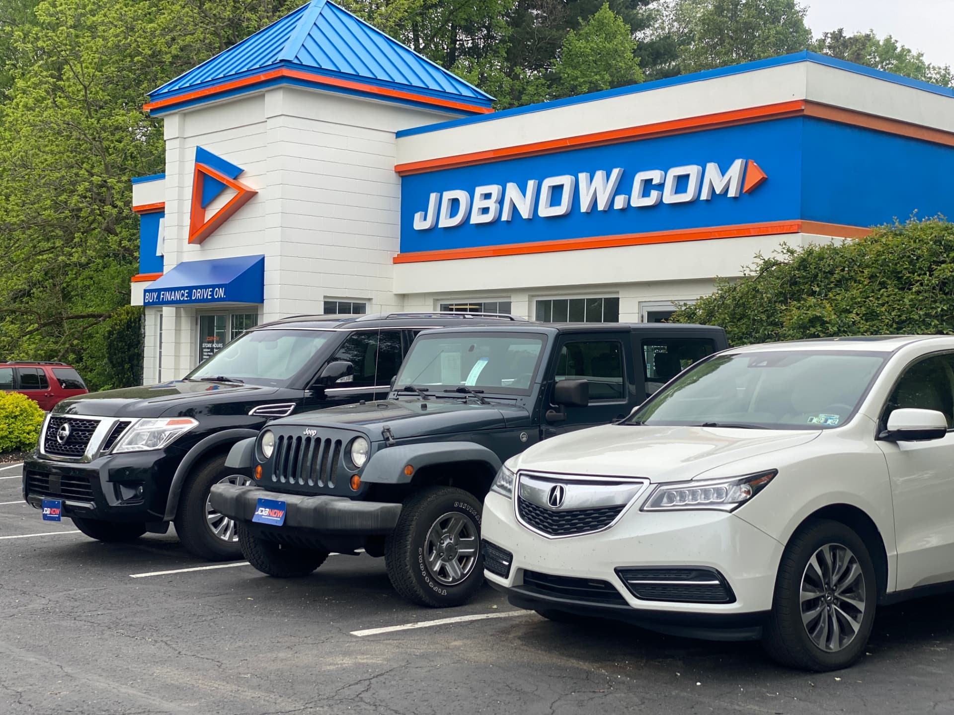 Byrider Wooster used car dealership storefront at 4536 Cleveland Rd, Wooster, Ohio, with a Nissan Armada, Jeep Wrangler and Acura MDX on the lot