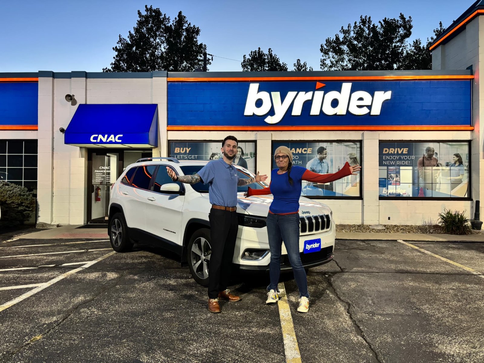 Byrider Amherst customer and salesperson their used Jeep Cherokee at the Amherst, Ohio dealership