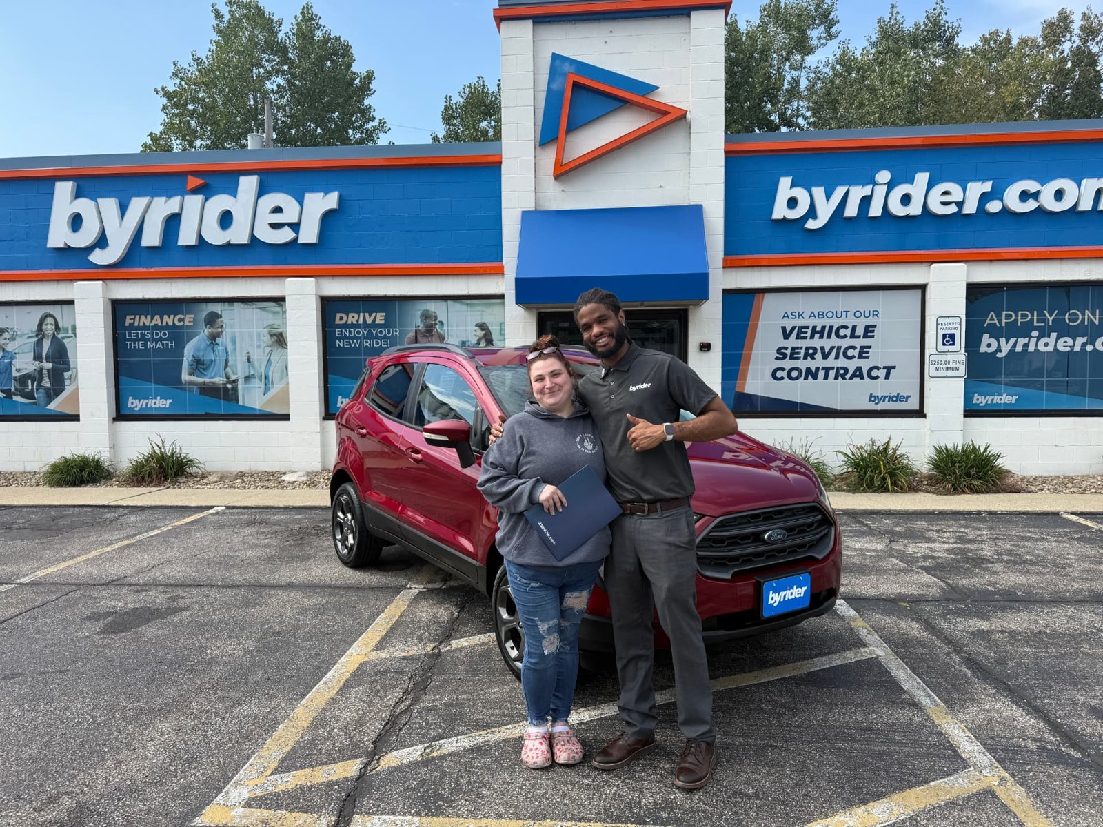 Byrider Amherst customer and salesperson with their used Ford EcoSport at the Amherst, Ohio dealership