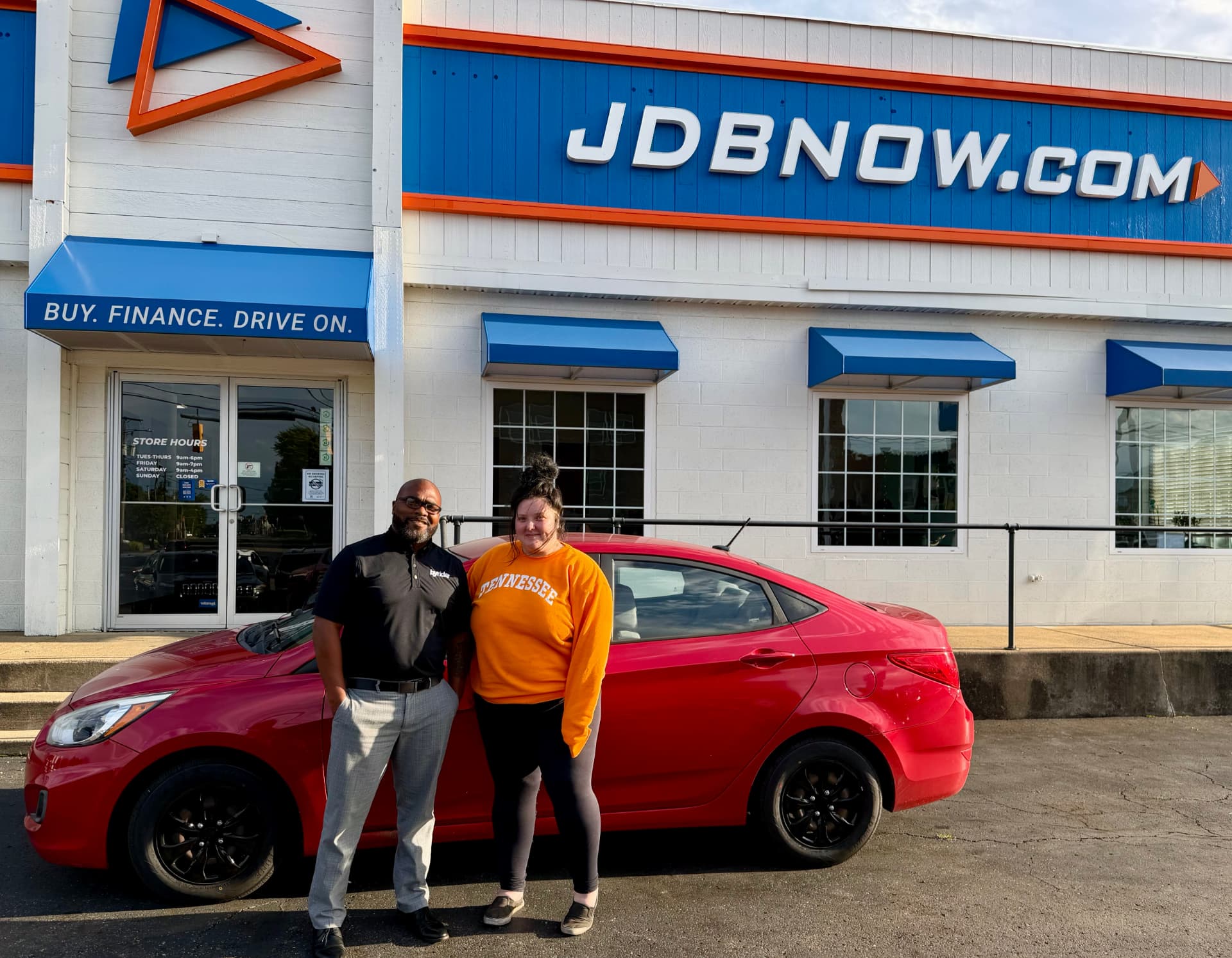 Byrider Canton salesperson and customer with their used Hyundai Accent at the Canton, Ohio dealership